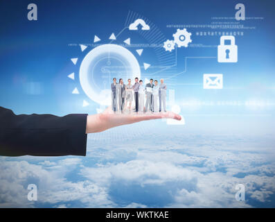 Business team looking at camera against blue sky over clouds at high altitude Stock Photo
