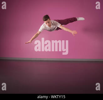 Cool break dancer mid air in the dance studio Stock Photo