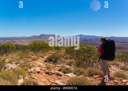 Hiker at the top of Mount Gillen just outside Alice Springs in central Australia. Stock Photo