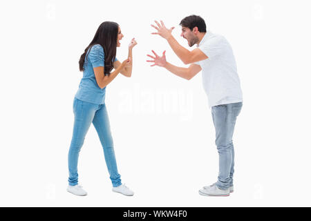 Angry couple shouting at each other on white background Stock Photo