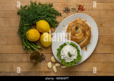 Spanakopita or spinach pie is a Greek savory pastry.The filling comprises chopped spinach, feta cheese, onions or spring onions, egg, and seasoning Stock Photo