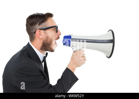 Geeky businessman shouting through megaphone on white background Stock Photo