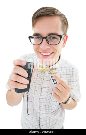 Geeky hipster speaking into dictaphone on white background Stock Photo