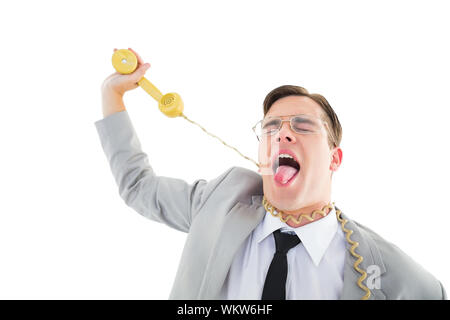 Geeky businessman being strangled by phone cord on white background Stock Photo