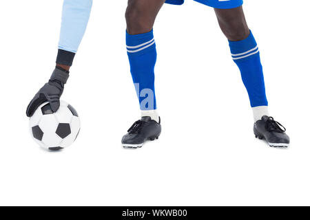 Goalkeeper in blue making a save on white background Stock Photo