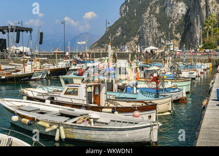 ISLE OF CAPRI, ITALY - AUGUST 2019: Small fishing boats tied up in the harbour on the Isle of Capri. Stock Photo
