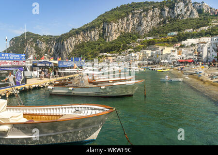 ISLE OF CAPRI, ITALY - AUGUST 2019: Small boats moored on the waterfront in the port on the Isle of Capri Stock Photo