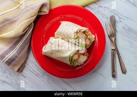 Crispy chicken Caesar salad wrap sandwich with romaine lettuce Stock Photo