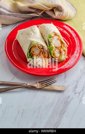 Crispy chicken Caesar salad wrap sandwich with romaine lettuce Stock Photo