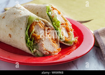 Crispy chicken Caesar salad wrap sandwich with romaine lettuce Stock Photo