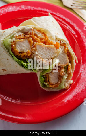 Crispy chicken Caesar salad wrap sandwich with romaine lettuce Stock Photo