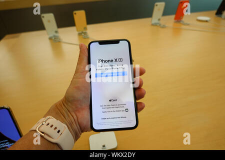 Orlando,FL/USA-8/27/19: A woman holding the latest iPhone X on display at a retail store. Stock Photo