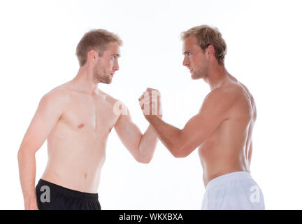 Two naked men fighting and wrestling, isolated on white background