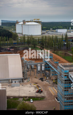 Large industrial tanks for petrochemical plant, oil and gas fuel or water in refinery or power plant for industrial plant on blue sky background. Stock Photo