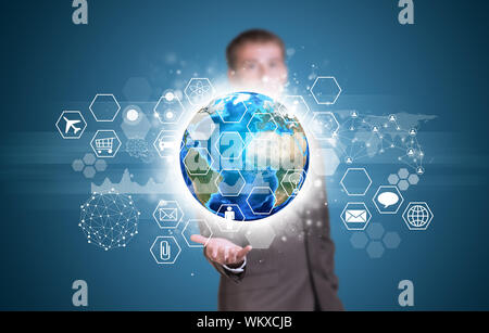 Businessman in suit hold Earth with graphs, hexagons, icons and network. Elements of this image are furnished by NASA Stock Photo