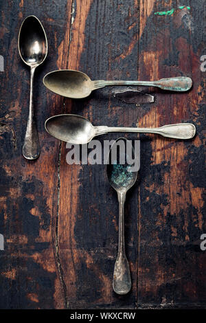 Vintage metal spoons on wooden background Stock Photo