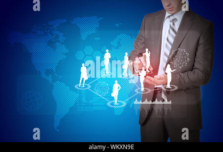 Businessman in suit hold empty copy space. World map with businesswoman silhouettes Stock Photo