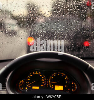 dashboard and rain droplets on car windshield Stock Photo