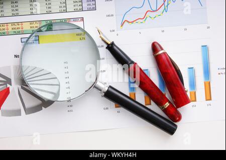 Graphs tables and documents laid on the table Stock Photo