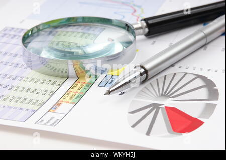 Graphs tables and documents laid on the table Stock Photo
