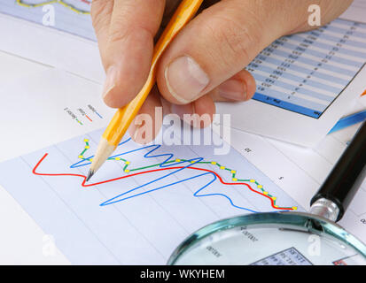 Graphs tables and documents laid on the table Stock Photo