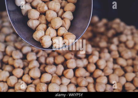 spoon with roasted hazelnuts on hazelnut background. Prepared with the harvest of hazelnuts. Flat lay. Stock Photo