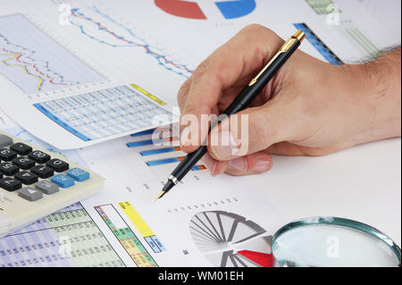 Graphs tables and documents laid on the table Stock Photo