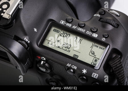 Professional modern DSLR camera - detail of the top LCD with settings - shutter speer, aperture, ISO, AF mode, battery info, RAW format indication,... Stock Photo