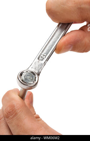 screw with a wrench in hands isolated on white background Stock Photo