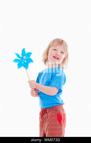 studio shot of a boy playing with pinwheel - isolated on white Stock Photo