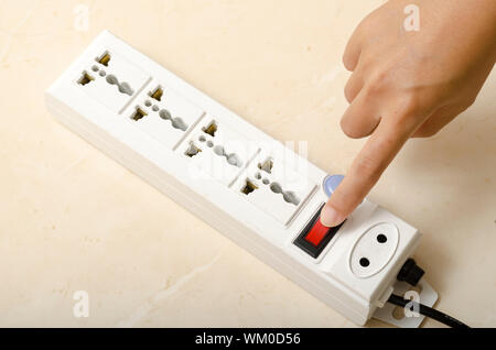 hand turn on switch multiple  socket plug Stock Photo