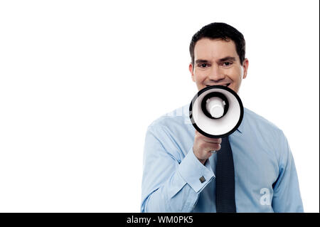 Happy man making announcement over a megaphone Stock Photo