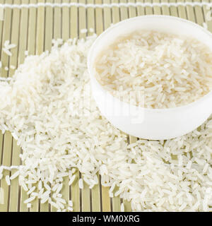 uncooked rice in mini bowl on wooden pad Stock Photo - Alamy