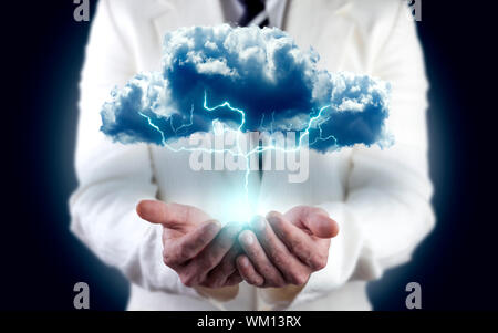 concept of energy and electricity. Businessman holding cloud with lightning Stock Photo