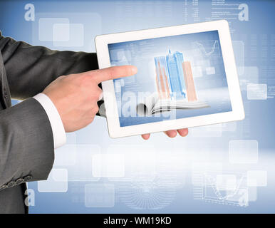 Man hands using tablet pc. Image of wire-frame buildings and open book on tablet screen Stock Photo