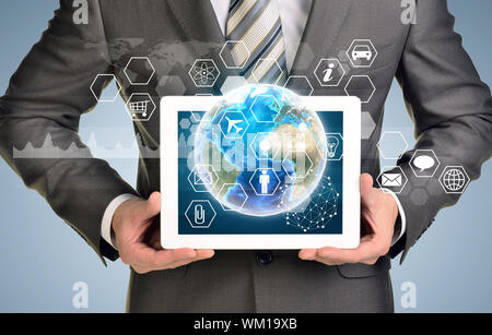 Man hands using tablet pc. Image of Earth and hexagons with icons on tablet screen. Element of this image furnished by NASA Stock Photo