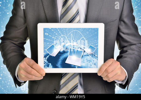 Man hands using tablet pc. Image of Earth and laptops on tablet screen. Element of this image furnished by NASA Stock Photo