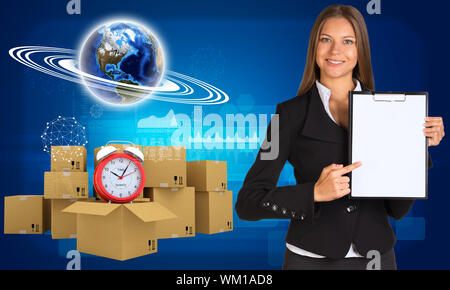Businesswoman hold paper holder. Earth and heap of cardboard boxes with alarm clock as backdrop. Element of this image furnished by NASA Stock Photo