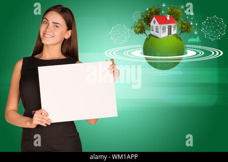 Beautiful businesswoman in dress holding paper holder. Earth with house and trees in background Stock Photo
