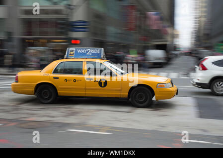 A Ford Crown Victoria Yellow Cab on 6th Avenue in Manhattan.  The Crown Vic was once omnipresent on the streets of NY but are now getting quite rare. Stock Photo