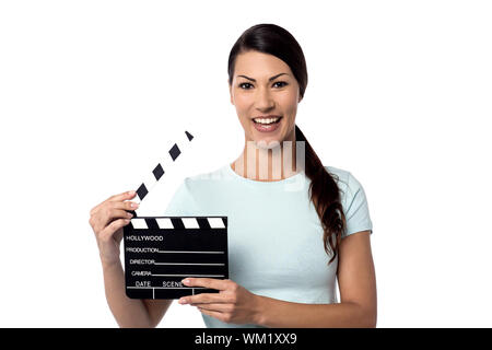 Young woman showing a clapperboard to camera Stock Photo