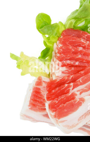 Frame of Sliced Raw Pork Bacon with Lettuce isolated on white background Stock Photo