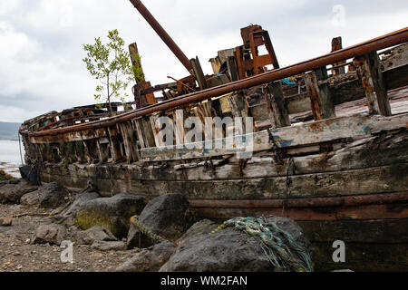 Old fishing boats wrecked on a beach on the Isle of Mull, Inner Hebrides, Scotland Stock Photo