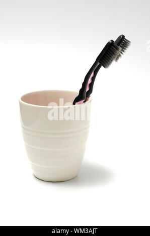 tooth brush in glass on a white background Stock Photo
