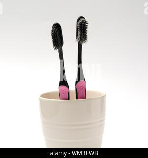 tooth brush in glass on a white background Stock Photo