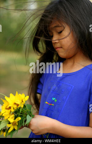 Little girl holding bouquet of sunflowers Stock Photo