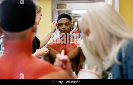 Hamburg, Germany. 14th Aug, 2019. The South African singer Hope Maine is made up in the mask. As the first cast he plays the Simba in the Hamburg production of the musical König der Löwen. Credit: Markus Scholz/dpa/Alamy Live News Stock Photo