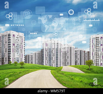 Road running through green hills with some trees on them towards high-rise buildings. Rectangles, diagrams and other virtual items in sky. Stock Photo