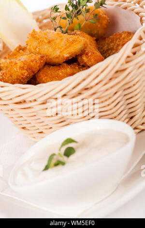 Crumbed chicken nuggets in a basket Stock Photo