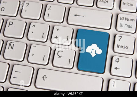 Spanish keyboard with technology cloud download icon over blue background button. Image with clipping path for easy change the key color and editing. Stock Photo